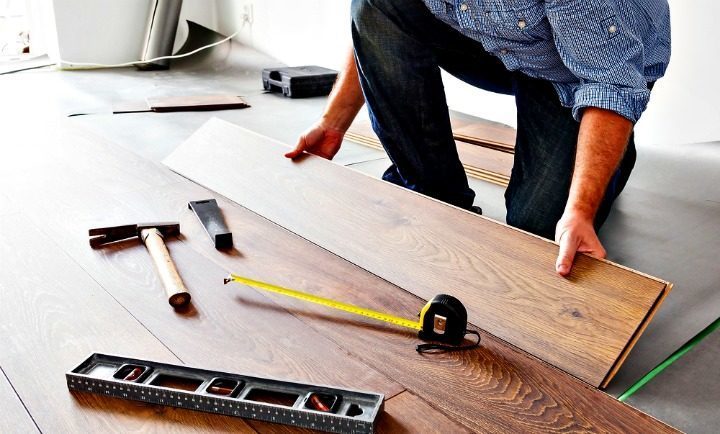Flooring Company Worker Installing Floor Planks