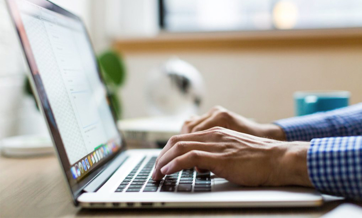 Man Typing On Laptop